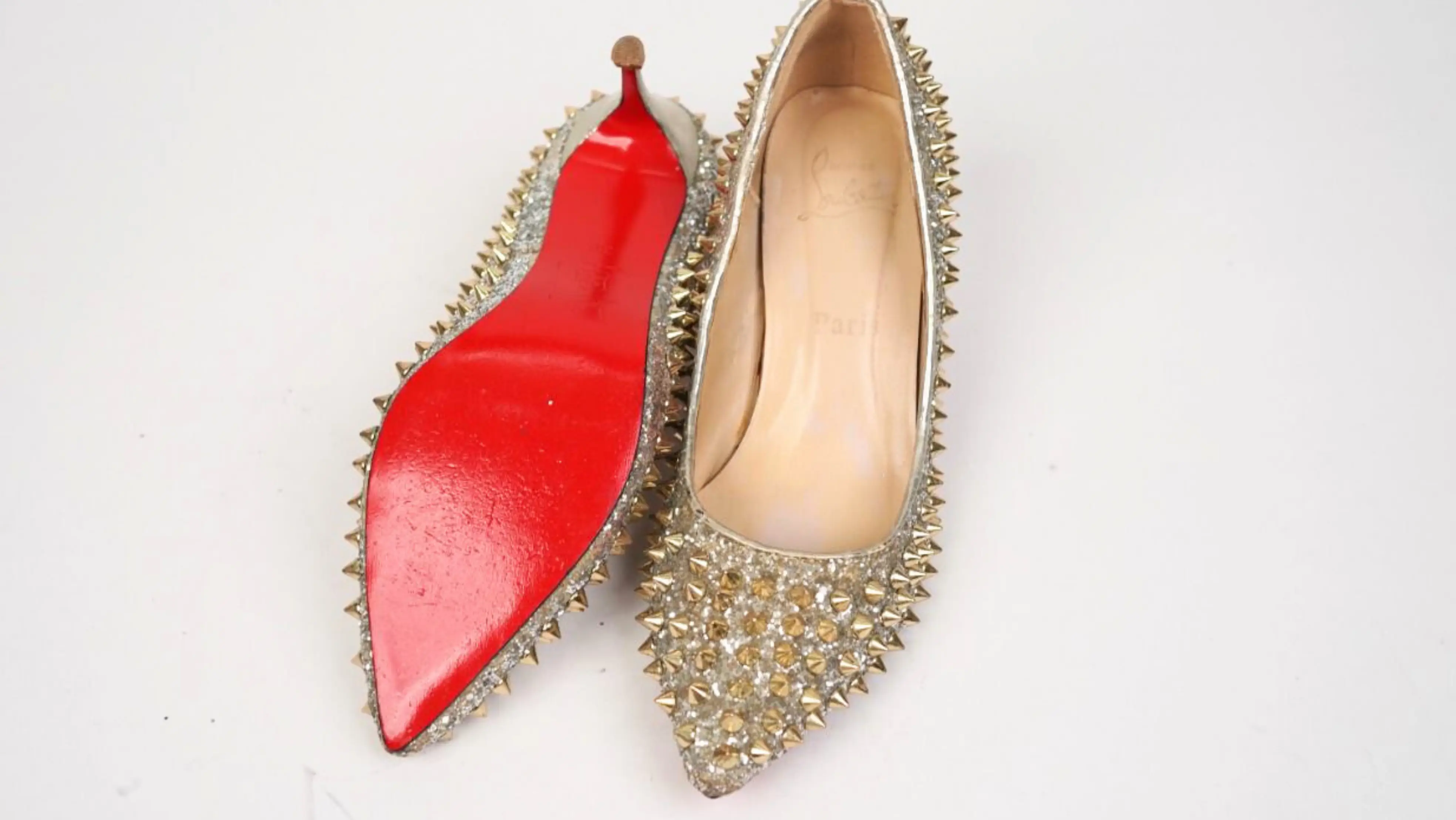Before Louboutin footwear repair showing scuffed, faded surface