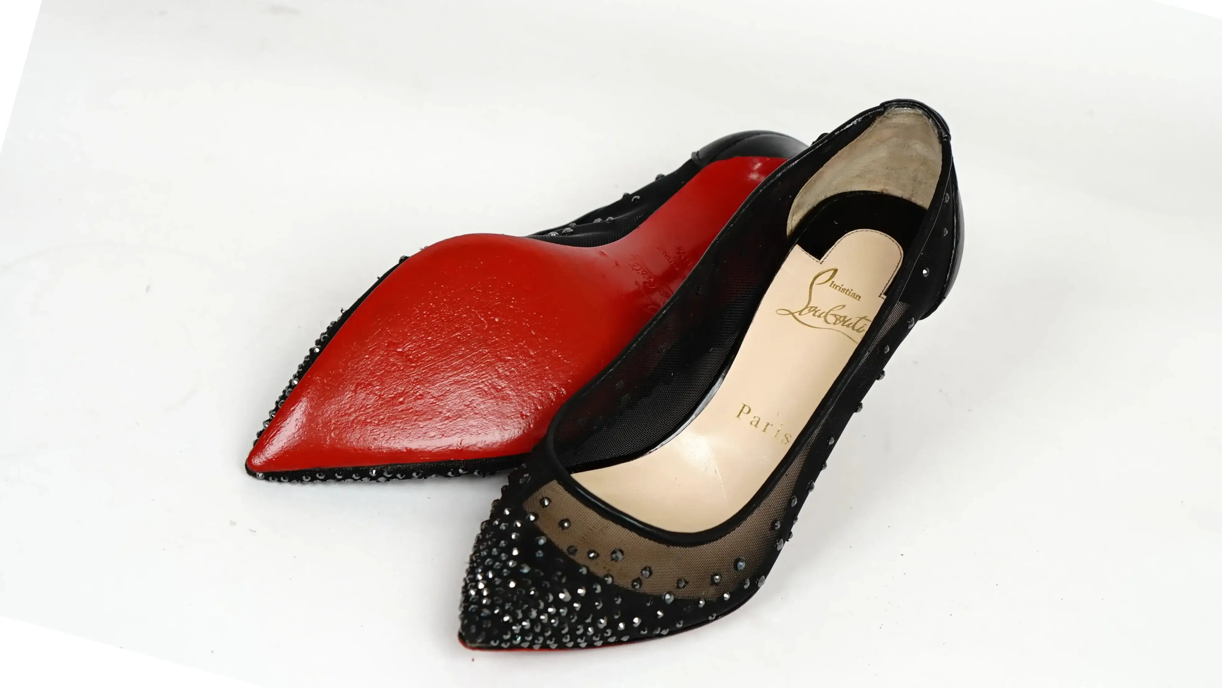 Before Louboutin red sole colour restoration showing worn outsole