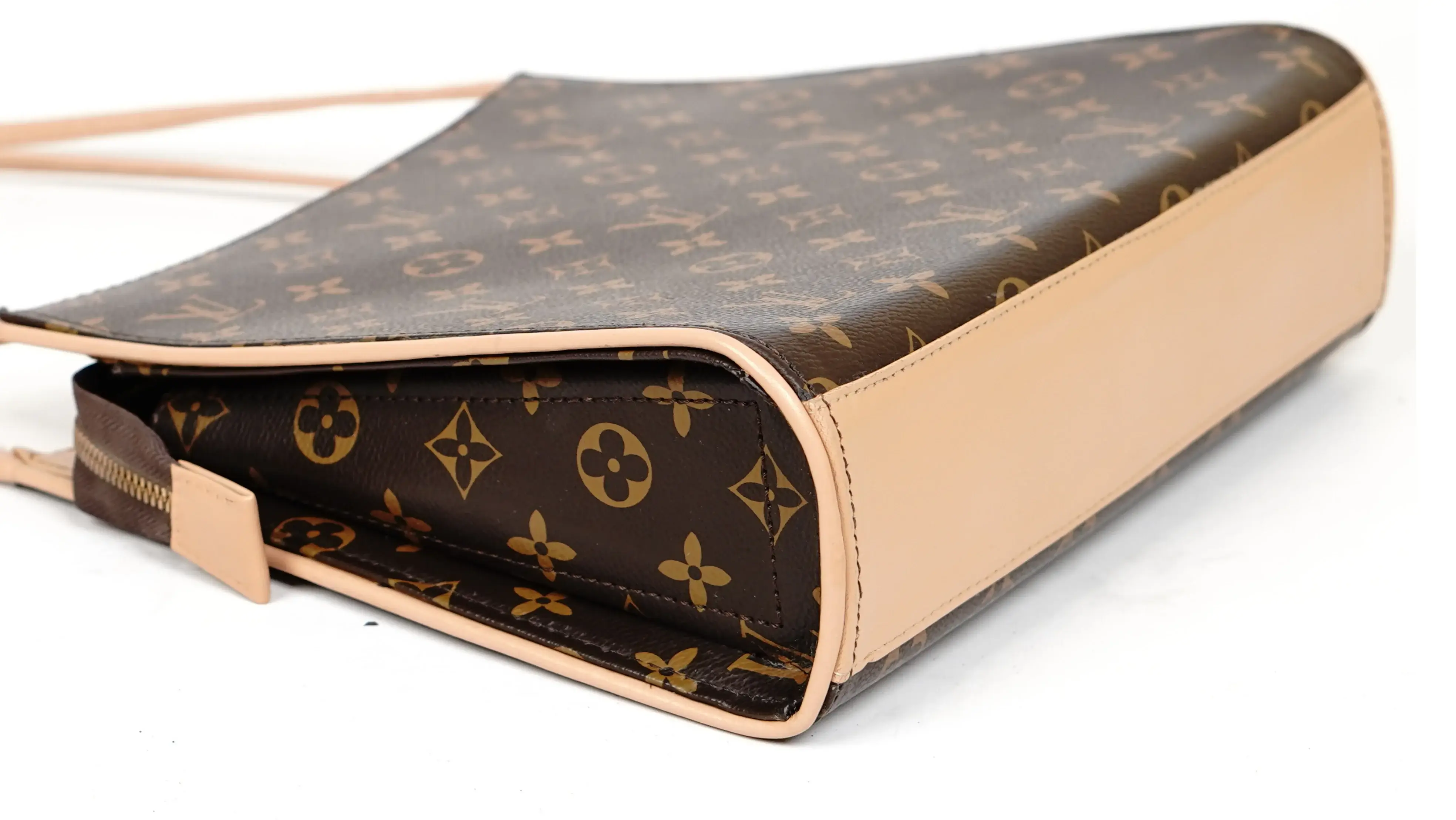 Before Louis Vuitton handbag restoration damaged panel with faded and uneven colour